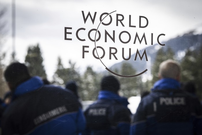 Police assembles outside the congress center on the eve of the 52nd annual meeting of the World Economic Forum, WEF, in Davos, Switzerland, Sunday, Jan. 15, 2023. The meeting brings together entrepreneurs, scientists, corporate and political leaders in Davos under the topic Cooperation in a Fragmented World from 16 to 20 January. (Gian Ehrenzeller/Keystone via AP)