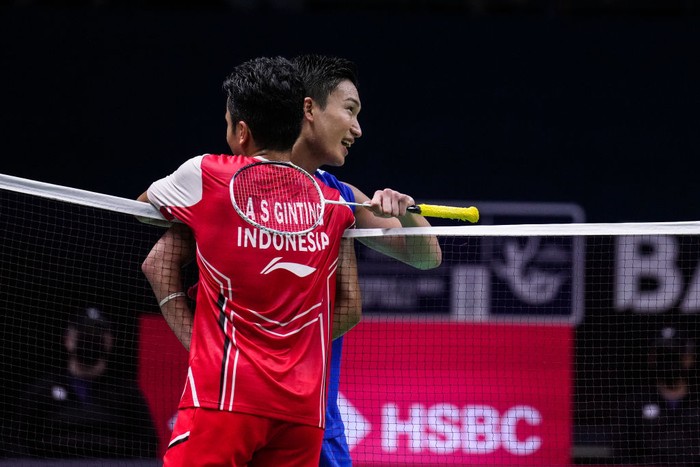 BANGKOK, THAILAND - MAY 13: Anthony Sinisuka Ginting (L) of Indonesia greets Kento Momota of Japan after their Thomas Cup Semi Final Mens Single match during day six of the BWF Thomas and Uber Cup Finals at Impact Arena on May 13, 2022 in Bangkok, Thailand. (Photo by Shi Tang/Getty Images)