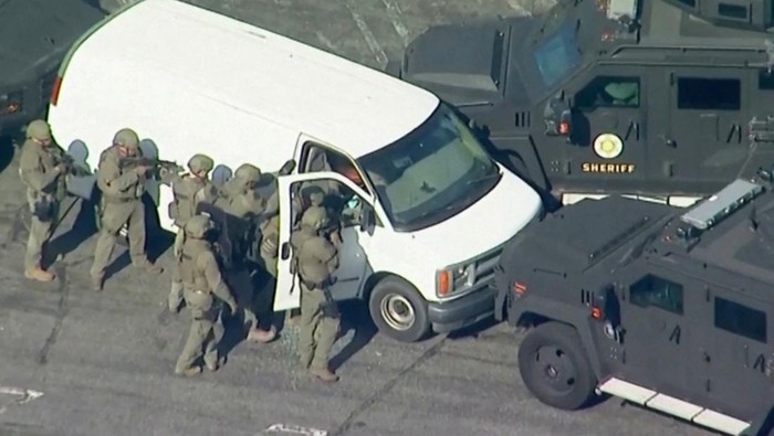 Police use armored vehicles to surround a white cargo van, believed by law enforcement to be connected to the Monterey Park mass shooting suspect according to an ABC affiliate, as a SWAT team approaches at a parking lot in Torrance, California, U.S. January 22, 2023 in a still image from video. ABC Affiliate KABC via REUTERS NO RESALES. NO ARCHIVES. MANDATORY CREDIT