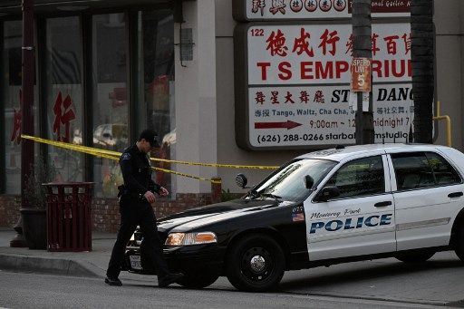 Police work near the scene of a mass shooting in Monterey Park, California, on January 22, 2023. - Ten people have died and at least 10 others have been wounded in a mass shooting in a largely Asian city in southern California, police said, with the suspect still at large hours later. (Photo by Robyn BECK / AFP)