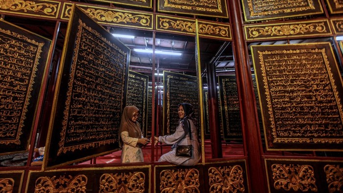 PALEMBANG, INDONESIA - JANUARY 23: People visit the Bayt Al Quran Al Akbar Museum in Palembang, Indonesia on January 23, 2023. Parts of Holy Quran were beautifully carved on the 1,77 x 1,4 meters wide and 2,5 cm thick Tembesu wood at the 5-storey building. (Photo by Muhammad A.F/Anadolu Agency via Getty Images)
