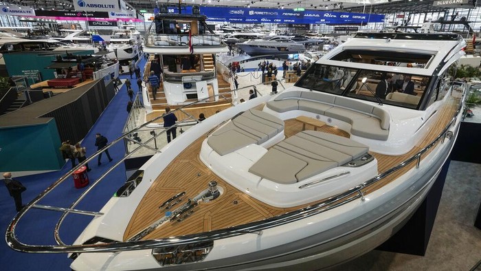 An electric boat is charged while it is on display for sale at the boat show in Duesseldorf, Germany, Monday, Jan. 23, 2023. (AP Photo/Martin Meissner)