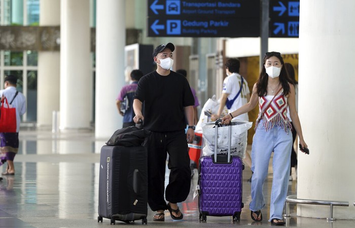 Chinese tourists arrive at Ngurah Rai international airport in Bali, Indonesia on Sunday, Jan. 22, 2023. A direct flight from China landed in Indonesias resort island of Bali for the first time on Sunday in nearly three years after the route was cancelled due to the pandemic.  (AP Photo/Firdia Lisnawati)