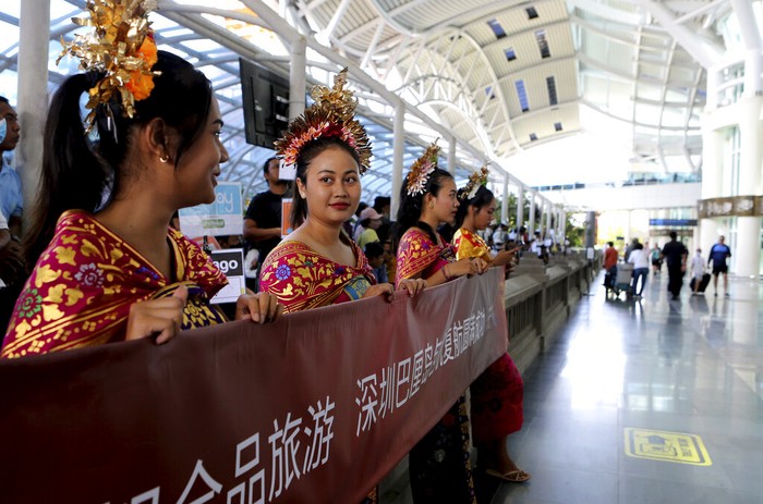 Chinese tourists arrive at Ngurah Rai international airport in Bali, Indonesia on Sunday, Jan. 22, 2023. A direct flight from China landed in Indonesias resort island of Bali for the first time on Sunday in nearly three years after the route was cancelled due to the pandemic.  (AP Photo/Firdia Lisnawati)
