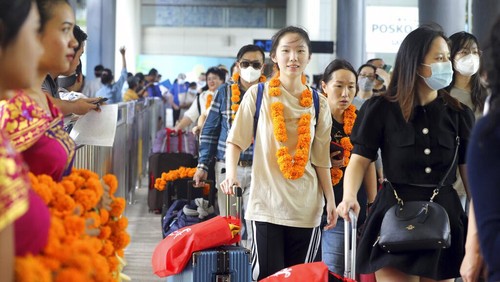Chinese tourists arrive at Ngurah Rai international airport in Bali, Indonesia on Sunday, Jan. 22, 2023. A direct flight from China landed in Indonesias resort island of Bali for the first time on Sunday in nearly three years after the route was cancelled due to the pandemic.  (AP Photo/Firdia Lisnawati)