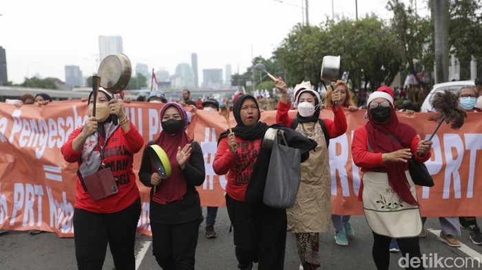 Pekera Rumah Tangga (PRT) menggelar aksi unjuk rasa di depan Gedung DPR RI, Jakarta Pusat, Rabu (25/01/2023). Dalam aksinya mereka membawa sejumlah alat masak seperti panci, penggorengan dan lainnya.