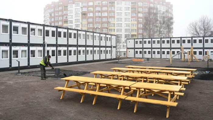 Workers put the finishing touches to a modular housing complex donated by the Polish government as humanitarian aid for the temporary accommodation of evacuees, in Lviv on January 24, 2023, amid the Russian invasion of Ukraine. (Photo by YURIY DYACHYSHYN / AFP) (Photo by YURIY DYACHYSHYN/AFP via Getty Images)