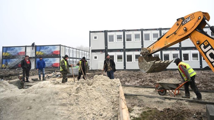 Polandia Bangun Rumah Darurat untuk Warga Ukraina, Begini Wujudnya Workers put the finishing touches to a modular housing complex donated by the Polish government as humanitarian aid for the temporary accommodation of evacuees, in Lviv on January 24, 2023, amid the Russian invasion of Ukraine. (Photo by YURIY DYACHYSHYN / AFP) (Photo by YURIY DYACHYSHYN/AFP via Getty Images)