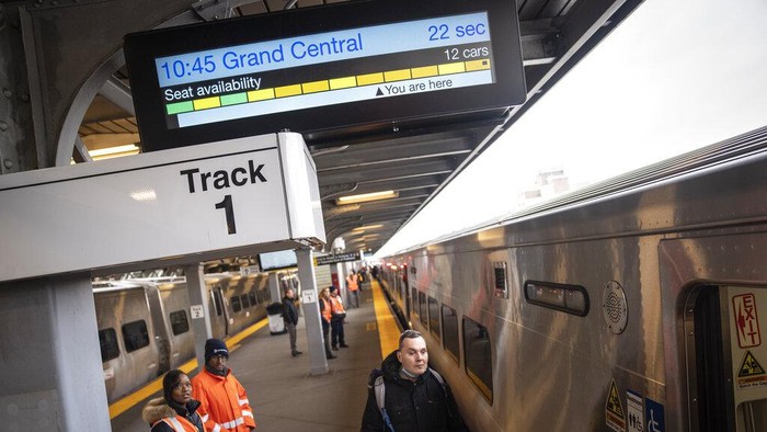 Antonio Hutchinson, an 8-year veteran conductor of the MTA, waits for his Long Island Rail Road train to depart for its inaugural trip from Jamaica station towards Grand Central Terminal, Wednesday, Jan. 25, 2023, in the Queens borough of New York. After years of delays and massive cost overruns, the railway project has begun shuttling its first passengers between Long Island to the latest addition to New York City's iconic Grand Central Terminal, dubbed Grand Central Madison because of its location along Madison Avenue.  (AP Photo/John Minchillo)