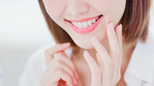 Close up of Beauty woman wear retainer for teeth happily