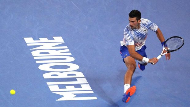 Novak Djokovic of Serbia plays a backhand return to Tommy Paul of the U.S. during their semifinal at the Australian Open tennis championship in Melbourne, Australia, Friday, Jan. 27, 2023. (AP Photo/Dita Alangkara)
