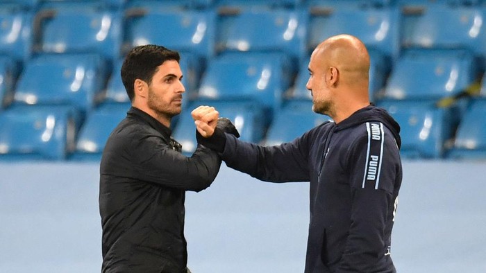 Arsenals Spanish head coach Mikel Arteta (L) bumps arms with Manchester Citys Spanish manager Pep Guardiola (R) at the end of the match during the English Premier League football match between Manchester City and Arsenal at the Etihad Stadium in Manchester, north west England, on June 17, 2020. - The Premier League makes its eagerly anticipated return today after 100 days in lockdown but behind closed doors due to coronavirus restrictions. (Photo by PETER POWELL / POOL / AFP) / RESTRICTED TO EDITORIAL USE. No use with unauthorized audio, video, data, fixture lists, club/league logos or live services. Online in-match use limited to 120 images. An additional 40 images may be used in extra time. No video emulation. Social media in-match use limited to 120 images. An additional 40 images may be used in extra time. No use in betting publications, games or single club/league/player publications. /  (Photo by PETER POWELL/POOL/AFP via Getty Images)