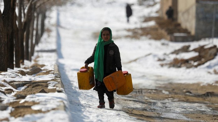 Afghan children play with each other on the snow-covered ground in Kabul, Afghanistan, January 26, 2023. REUTERS/Ali Khara