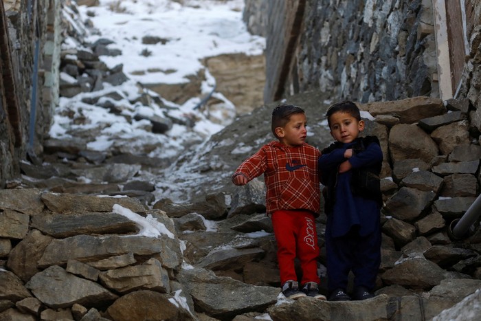 Afghan children play with each other on the snow-covered ground in Kabul, Afghanistan, January 26, 2023. REUTERS/Ali Khara