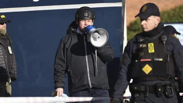 Far-right activist Rasmus Paludan speaks on a megaphone in front of a mosque in the Noerrebro area of Copenhagen, Denmark on Friday Jan. 27, 2023 where planned to burn the Quran. Turkey has summoned the Danish ambassador over reports that an anti-Islam activist will be allowed to burn the Quran on Friday during a series of protests in Copenhagen. (Olafur Steinar Gestsson/Ritzau Scanpix via AP)