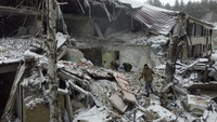 Seorang anggota dinas Rusia memindahkan puing-puing bangunan rumah sakit yang hancur di Novoaidar, Luhansk, Rusia, 29 Januari 2023.