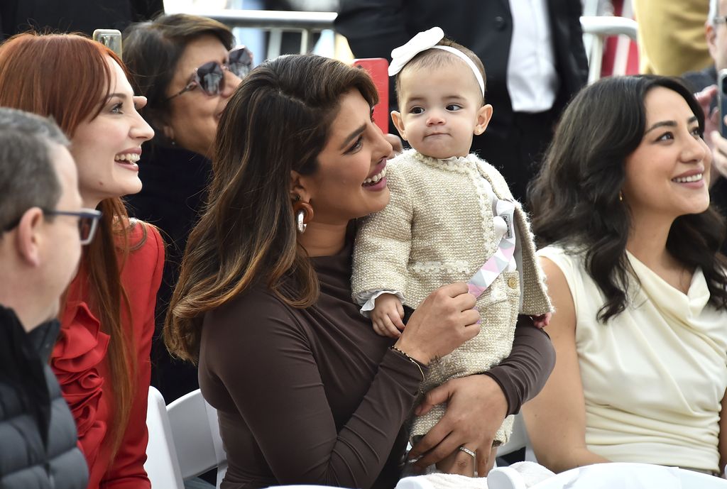Sophie Turner, from left, Priyanka Chopra and her daughter Malti Marie Chopra Jonas attend a ceremony honoring The Jonas Brothers with a star on The Hollywood Walk of Fame on Monday, Jan. 30, 2023, in Los Angeles. (Photo by Jordan Strauss/Invision/AP)