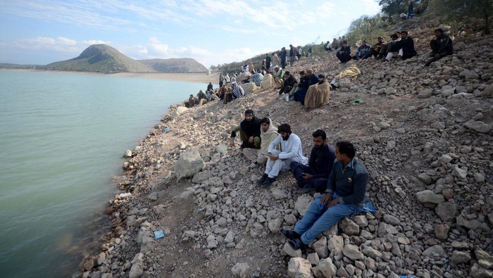 PESHAWAR, PAKISTAN, JANUARY, 30: Rescue workers perform a search operation for bodies after a boat capsized in Kohat dam, Pakistan, 30 January 2023. At least 50 children on Sunday died as a boat, carrying 50 to 55 passengers including madrassa students as well as the boatman, capsized in Kohatâs Tanda Dam, while the authorities were still searching for the rest of them. (Photo by Hussain Ali/Anadolu Agency via Getty Images)