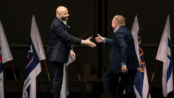 BOEING-747/ Actor John Travolta makes a surprise appearance and shakes hands with Stan Deal, president and CEO of Boeing Commercial Airplanes, during the delivery of the final 747 jet at the Boeing plant in Everett, Washington, U.S. January 31, 2023. REUTERS/David Ryderf