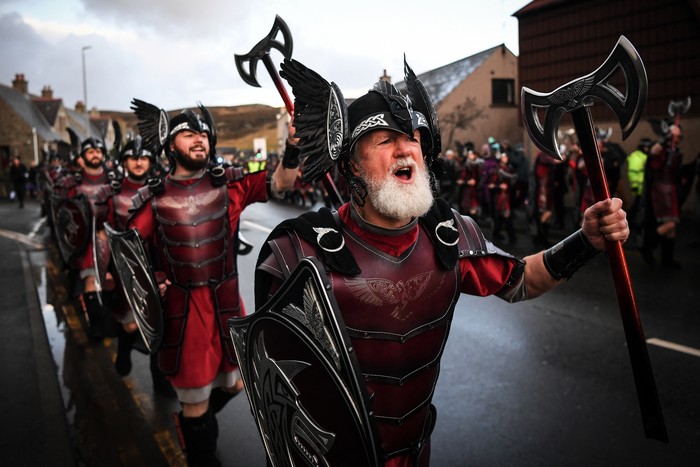 Members of the Up Helly Aa Jarl Squad parade through the streets in Lerwick, Shetland Islands on January 31, 2023 before the Up Helly Aa festival later in the day. - Up Helly Aa celebrates the influence of the Scandinavian Vikings in the Shetland Islands and culminates with up to 1,000 guizers (men in costume) throwing flaming torches into their Viking longboat and setting it alight later in the evening. (Photo by Andy Buchanan / AFP)