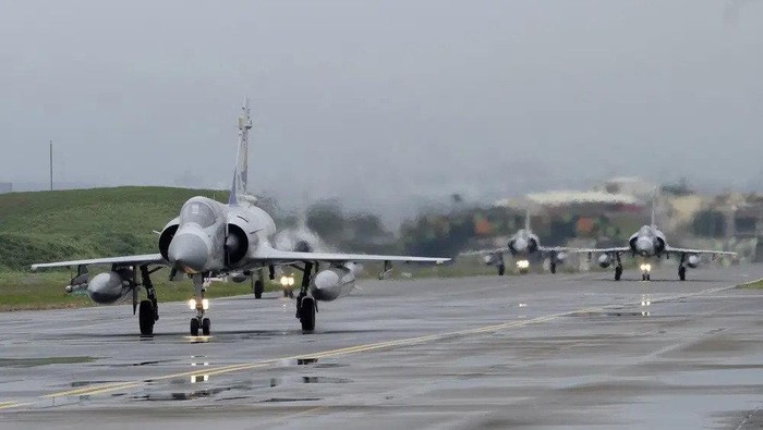 FILE - Taiwanese Mirage 2000 fighter jets taxi along a runway during a drill at an airbase in Hsinchu, Taiwan, Wednesday, Jan. 11, 2023. Taiwan scrambled fighter jets, put its navy on alert and activated missile systems Tuesday, Jan. 31, 2023, in response to nearby operations of 34 Chinese military aircraft and nine warships that are part Beijings strategy to unsettle and intimidate the self-governing island democracy. (AP Photo/Johnson Lai, File)