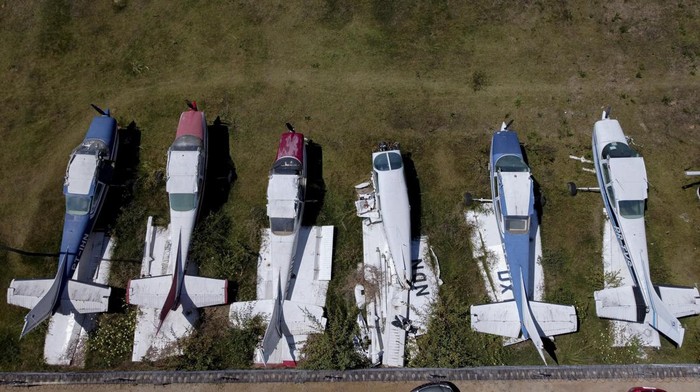 This aerial view shows planes and helicopters seized by the police during operations against illegal mining on indigenous territories at the courtyard of the Federal Police headquarters in Boa Vista, Roraima state, Brazil on January 31, 2023. (Photo by MICHAEL DANTAS / AFP) (Photo by MICHAEL DANTAS/AFP via Getty Images)