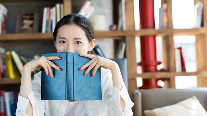 chinese female students in the library, reading a person alone