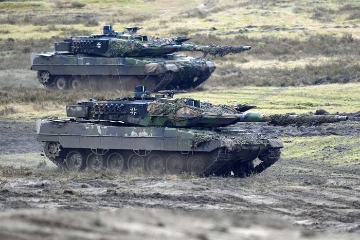 A Leopard 2 tank is seen in action during a visit of German Defense Minister Boris Pistorius at the Bundeswehr tank battalion 203 at the Field Marshal Rommel Barracks in Augustdorf, Germany, Wednesday, Feb. 1, 2023. After the governments decision to deliver fourteen Leopard 2 tanks to Ukraine, the capabilities of the Leopard 2A6 main battle tank are shown at a presentation in Augustdorf. (AP Photo/Martin Meissner)