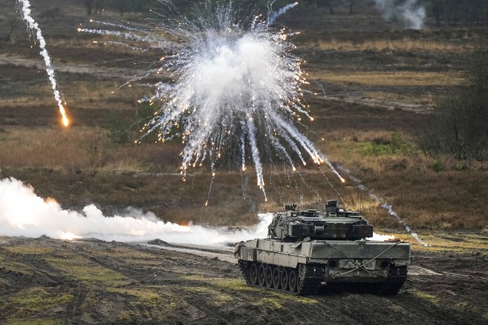 A Leopard 2 tank is seen in action during a visit of German Defense Minister Boris Pistorius at the Bundeswehr tank battalion 203 at the Field Marshal Rommel Barracks in Augustdorf, Germany, Wednesday, Feb. 1, 2023. After the governments decision to deliver fourteen Leopard 2 tanks to Ukraine, the capabilities of the Leopard 2A6 main battle tank are shown at a presentation in Augustdorf. (AP Photo/Martin Meissner)