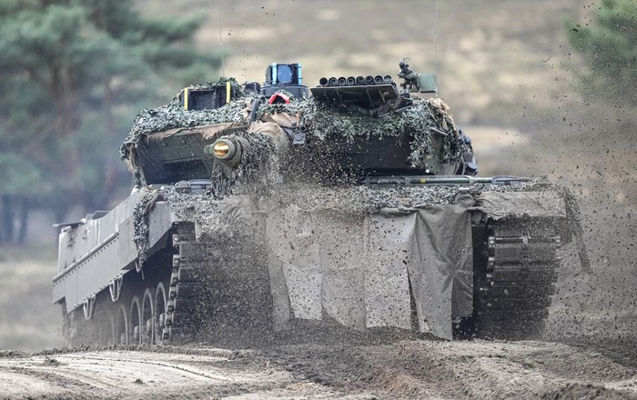 A Leopard 2 tank is seen in action during a visit of German Defense Minister Boris Pistorius at the Bundeswehr tank battalion 203 at the Field Marshal Rommel Barracks in Augustdorf, Germany, Wednesday, Feb. 1, 2023. After the governments decision to deliver fourteen Leopard 2 tanks to Ukraine, the capabilities of the Leopard 2A6 main battle tank are shown at a presentation in Augustdorf. (AP Photo/Martin Meissner)