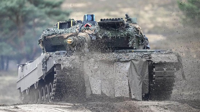 A Leopard 2 tank is seen in action during a visit of German Defense Minister Boris Pistorius at the Bundeswehr tank battalion 203 at the Field Marshal Rommel Barracks in Augustdorf, Germany, Wednesday, Feb. 1, 2023. After the governments decision to deliver fourteen Leopard 2 tanks to Ukraine, the capabilities of the Leopard 2A6 main battle tank are shown at a presentation in Augustdorf. (AP Photo/Martin Meissner)