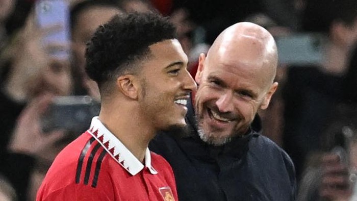 Manchester Uniteds Dutch manager Erik ten Hag (R) talks with Manchester Uniteds English striker Jadon Sancho as Sancho waits to be substituted on during the English League Cup semi-final second-leg  football match between Manchester United and Nottingham Forest at Old Trafford in Manchester, north west England, on February 1, 2023. - RESTRICTED TO EDITORIAL USE. No use with unauthorized audio, video, data, fixture lists, club/league logos or live services. Online in-match use limited to 120 images. An additional 40 images may be used in extra time. No video emulation. Social media in-match use limited to 120 images. An additional 40 images may be used in extra time. No use in betting publications, games or single club/league/player publications. (Photo by Paul ELLIS / AFP) / RESTRICTED TO EDITORIAL USE. No use with unauthorized audio, video, data, fixture lists, club/league logos or live services. Online in-match use limited to 120 images. An additional 40 images may be used in extra time. No video emulation. Social media in-match use limited to 120 images. An additional 40 images may be used in extra time. No use in betting publications, games or single club/league/player publications. / RESTRICTED TO EDITORIAL USE. No use with unauthorized audio, video, data, fixture lists, club/league logos or live services. Online in-match use limited to 120 images. An additional 40 images may be used in extra time. No video emulation. Social media in-match use limited to 120 images. An additional 40 images may be used in extra time. No use in betting publications, games or single club/league/player publications. (Photo by PAUL ELLIS/AFP via Getty Images)