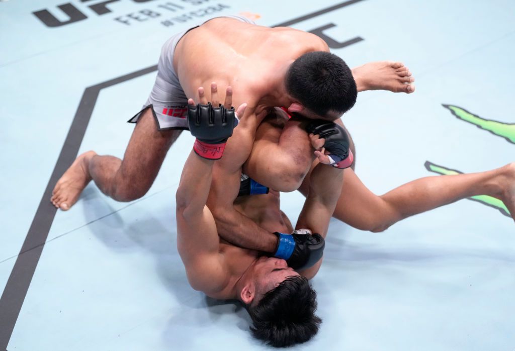 LAS VEGAS, NEVADA - FEBRUARY 04: (L-R) Anshul Jubli of India punches Jeka Saragih of Indonesia in a lightweight fight during the UFC Fight Night event at UFC APEX on February 04, 2023 in Las Vegas, Nevada. (Photo by Jeff Bottari/Zuffa LLC via Getty Images)