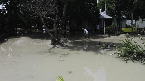 Sejumlah warga duduk di pinggiran sungai menyaksikan derasnya aliran air akibat jebolnya pintu air Bendungan Oesao di Desa Pukdale, Kabupaten Kupang, NTT, Minggu (5/2/2023). Jebolnya pintu air bendungan tersebut mengakibatkan 598 rumah terendam banjir dan dikhawatirkan berdampak pada gagal panen di daerah itu. ANTARA FOTO/Kornelis Kaha/tom.