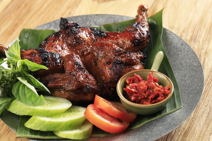 Bakakak Hayam or Ayam Bekakak or Grilled Whole Chicken Seasoning with Soy Sauce. Dish from West Java and Jakarta, Indonesia. Close Up