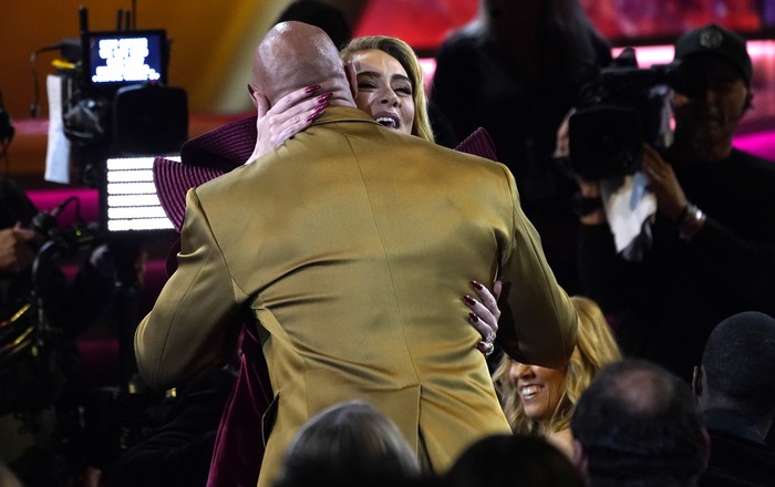 Adele, back, and Dwayne Johnson embrace at the 65th annual Grammy Awards on Sunday, Feb. 5, 2023, in Los Angeles. (AP Photo/Chris Pizzello)