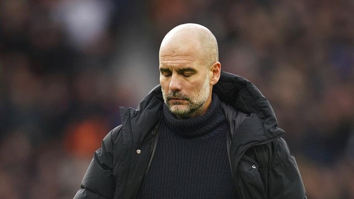 Manchester Citys head coach Pep Guardiola walks on the pitch after the English Premier League soccer match between Manchester United and Manchester City at Old Trafford in Manchester, England, Saturday, Jan. 14, 2023. (AP Photo/Dave Thompson)
