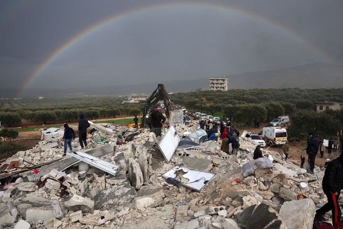 Residents search for victims and survivors amidst the rubble of collapsed buildings following an earthquake in the village of Besnaya in Syrias rebel-held northwestern Idlib province on the border with Turkey, on February 6, 2022. - At least 1,293 people were killed and 3,411 injured across Syria today in an earthquake that had its epicentre in southwestern Turkey, the government and rescuers said. (Photo by OMAR HAJ KADOUR / AFP) (Photo by OMAR HAJ KADOUR/AFP via Getty Images)