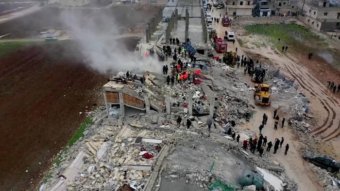 Rescuers search through rubble of collapsed buildings following an earthquake, in the rebel-held town of Sarmada, Syria February 6, 2023 in this still obtained from a video. White Helmets/via REUTERS ATTENTION EDITORS - THIS IMAGE HAS BEEN SUPPLIED BY A THIRD PARTY. MANDATORY CREDIT. NO RESALES. NO ARCHIVES.