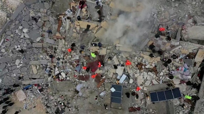 Rescuers search through rubble of collapsed buildings following an earthquake, in the rebel-held town of Sarmada, Syria February 6, 2023 in this still obtained from a video. White Helmets/via REUTERS ATTENTION EDITORS - THIS IMAGE HAS BEEN SUPPLIED BY A THIRD PARTY. MANDATORY CREDIT. NO RESALES. NO ARCHIVES.