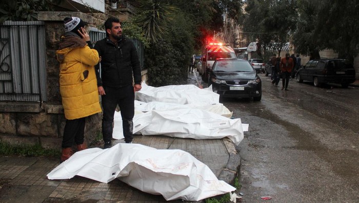 Rescuers search for survivors at the site of a collapsed building, following an earthquake, in Aleppo, Syria, February 6, 2023 in this handout image. SANA/Handout via REUTERS ATTENTION EDITORS - THIS IMAGE WAS PROVIDED BY A THIRD PARTY. REUTERS IS UNABLE TO INDEPENDENTLY VERIFY THIS IMAGE.
