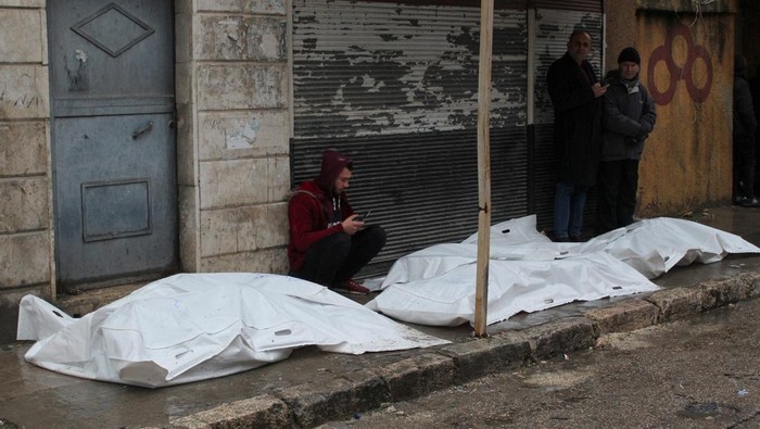 Rescuers search for survivors at the site of a collapsed building, following an earthquake, in Aleppo, Syria, February 6, 2023 in this handout image. SANA/Handout via REUTERS ATTENTION EDITORS - THIS IMAGE WAS PROVIDED BY A THIRD PARTY. REUTERS IS UNABLE TO INDEPENDENTLY VERIFY THIS IMAGE.