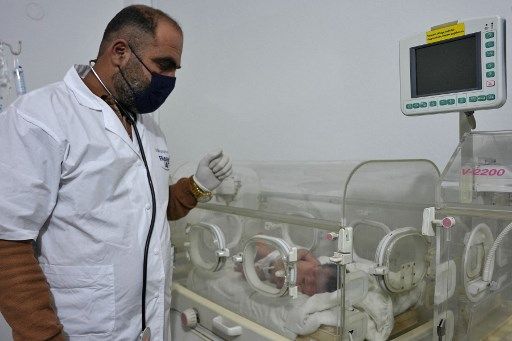EDITORS NOTE: Graphic content / A newborn baby who was found still tied by her umbilical cord to her mother and pulled alive from the rubble of a home in northern Syria following a deadly earthquake, receives medical care from doctor Hani Maaruf, at a clinic in Afrin, on February 7, 2023. - The infant is the sole survivor of her immediate family, the rest of whom were all killed when a 7.8-magnitude quake that struck Syria and neighbouring Turkey flattened the family home in the rebel-held town of Jindayris, cousin Khalil al-Suwadi said. (Photo by Rami al SAYED / AFP)