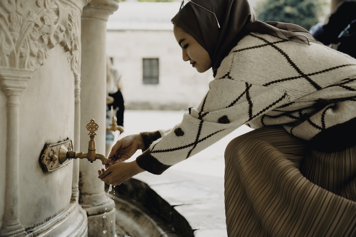 Muslim woman taking ablution for prayer