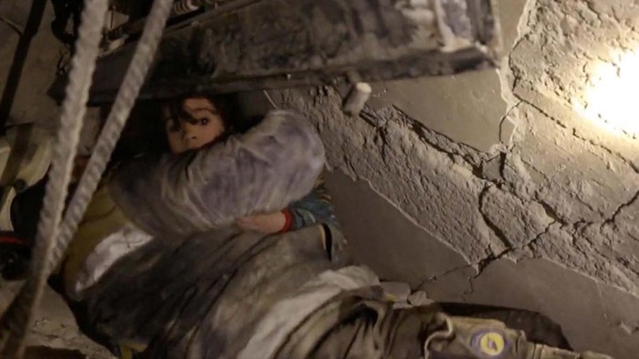 A child is being rescued from the rubble caused by the earthquake in rebel-held town of Jandaris, Syria, February 7, 2023 in this picture obtained from social media. White Helmets/via REUTERS THIS IMAGE HAS BEEN SUPPLIED BY A THIRD PARTY. MANDATORY CREDIT. NO RESALES. NO ARCHIVES.