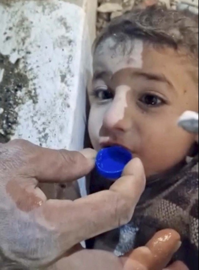 A boy is rescued from the rubble following an earthquake in Hatay, Turkey February 7, 2023 in this still image taken from video.  Istanbul Municipality/Handout via REUTERS  THIS IMAGE HAS BEEN SUPPLIED BY A THIRD PARTY.