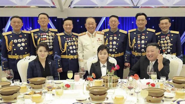 In this photo provided by the North Korean government, North Korean leader Kim Jong Un, front right, with his wife Ri Sol Ju, front left, and his daughter poses with military top officials for a photo at a feast to mark the 75th founding anniversary of the Korean People's Army at an unspecified place in North Korea Tuesday, Feb. 7, 2023. Independent journalists were not given access to cover the event depicted in this image distributed by the North Korean government. The content of this image is as provided and cannot be independently verified. Korean language watermark on image as provided by source reads: 