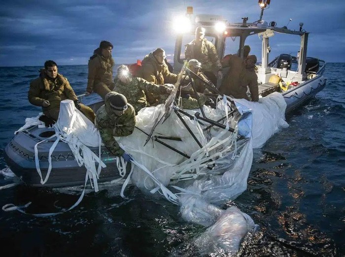 This image provided by the U.S. Navy shows sailors assigned to Explosive Ordnance Disposal Group 2 recovering a high-altitude surveillance balloon off the coast of Myrtle Beach, S.C., Feb. 5, 2023. (U.S. Navy via AP)
