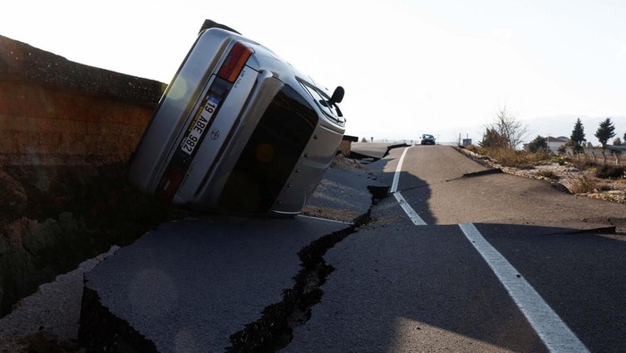 A car is pictured on an earthquake damaged D420 road in Demirkopru, Turkey, February 8, 2023. REUTERS/Benoit Tessier