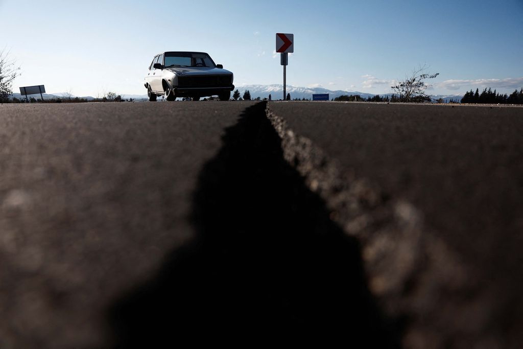 A car is pictured on an earthquake damaged D420 road in Demirkopru, Turkey, February 8, 2023. REUTERS/Benoit Tessier